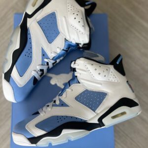A pair of Jordan 6 "UNC" basketball shoes in size 7.5 men's/9 women's displayed on a blue box, priced at $250. the shoes are white and blue with a jumpman logo.