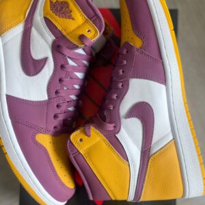 A pair of "Air Jordan 1 Retro High OG Brotherhood" sneakers in size 11m, predominantly white and purple with yellow accents, priced at $220, displayed on a box.