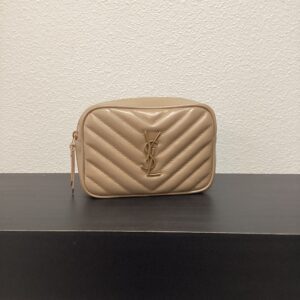 Beige quilted leather YSL 2 Way Belt Bag with a prominent ysl logo on the front, displayed on a dark shelf against a white wall.