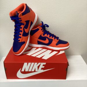 A pair of Nike Dunk High Orange/Deep/Royal sneakers placed on top of their shoebox, displayed against a plain white background.
